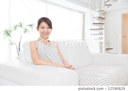 A woman relaxing in the room A woman relaxing in the room 12590829