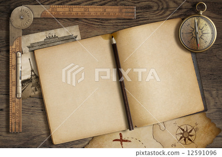 Open blank diary with map, pencil and compass. Adventure and travel nautical theme.   12591096