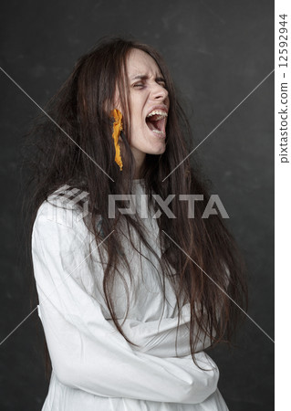 Crazy woman screaming in a straitjacket. 12592944
