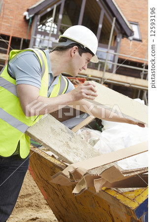 Builder Putting Waste Into Rubbish Skip 12593196