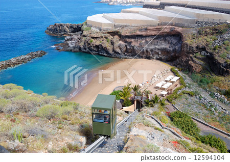 View on a beach of luxury hotel and banana's plantation at backg View on a beach of luxury hotel and banana's plantation at backg 12594104