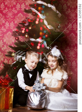 Happy children with christmas presents Happy children with christmas presents 12595592