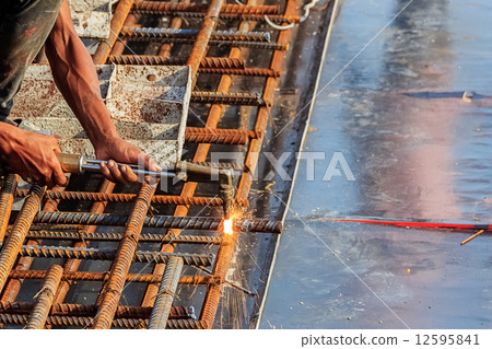 Welder in Cutting steel bar 12595841
