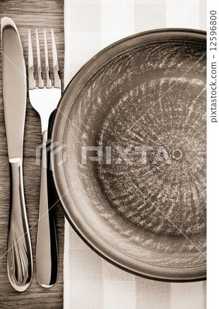 plate, knife and fork at napkin on wood plate, knife and fork at napkin on wood 12596800