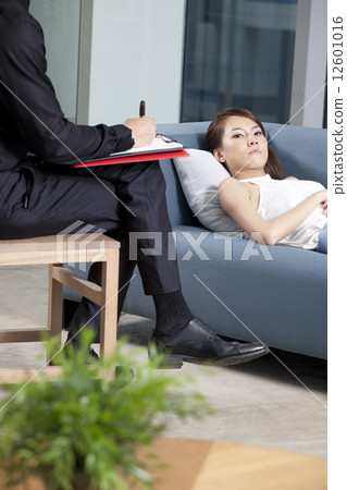 Depressed patient lying on couch Depressed patient lying on couch 12601016