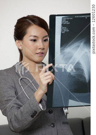 Chinese female doctor holding xray Chinese female doctor holding xray 12601230