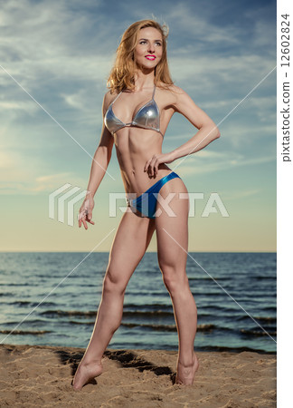 Sexy woman in bikini posing on the beach Sexy woman in bikini posing on the beach 12602824