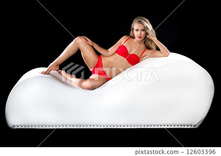 Sexy blond woman posing a tantra chair 12603396