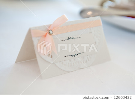 White place card decorated with orange bow White place card decorated with orange bow 12603422