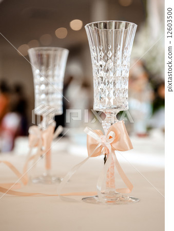Champagne glasses decorated with orange bows Champagne glasses decorated with orange bows 12603500