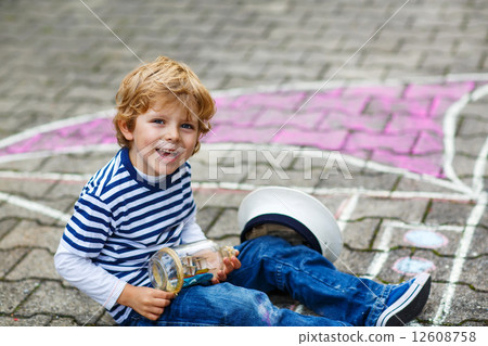Little boy having fun with ship picture drawing with chalk Little boy having fun with ship picture drawing with chalk 12608758