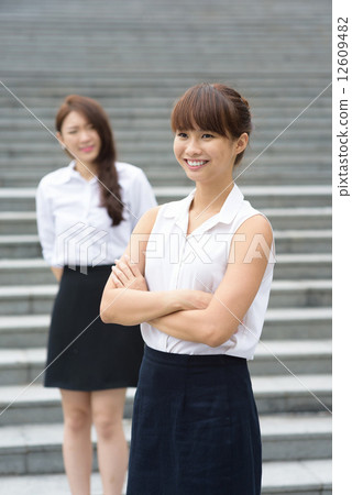 2 young successful chinese office lady in front of steps outdoor 2 young successful chinese office lady in front of steps outdoor 12609482