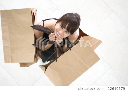 Top down view of one young chinese shopaholic with shopping bags Top down view of one young chinese shopaholic with shopping bags 12610679