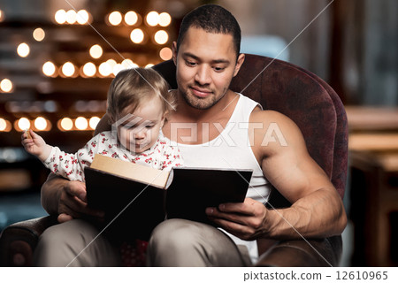 Father reading book to daughter Father reading book to daughter 12610965