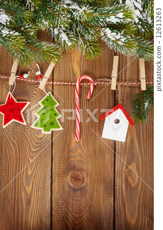 Snow fir tree and christmas decor on rope 12613263