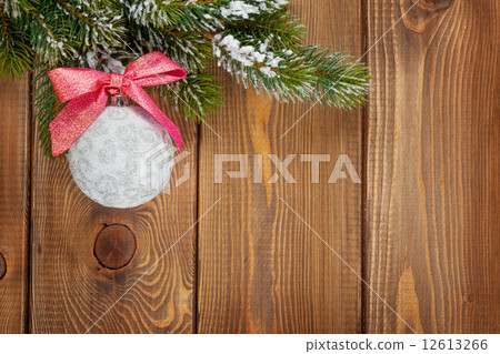 Christmas fir tree and bauble with red ribbon Christmas fir tree and bauble with red ribbon 12613266