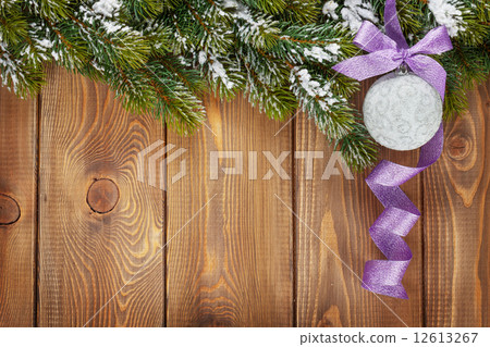 Christmas fir tree and bauble with purple ribbon Christmas fir tree and bauble with purple ribbon 12613267