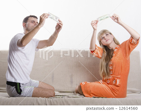 Young boy and girl define fake whether banknotes Young boy and girl define fake whether banknotes 12614560