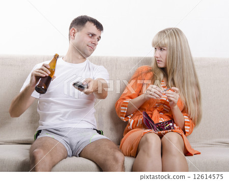 He drinking beer, she looks at him reproachfully 12614575