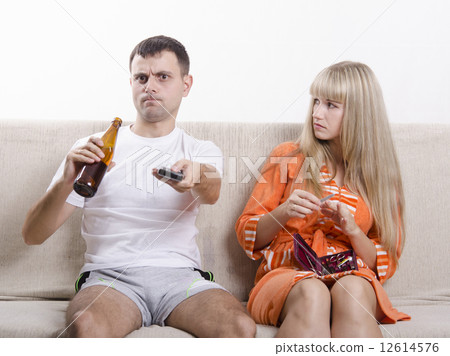 He drinking beer, she looks at him reproachfully 12614576