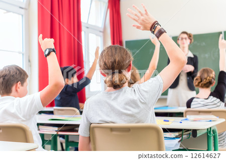 Teacher  educate or teaching a class of  pupils in school 12614627