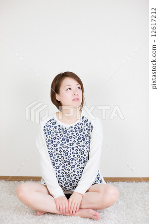 A young lady watching diagonally above the crane 12617212