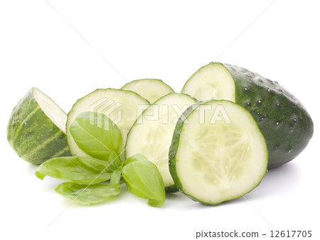 Sliced cucumber vegetable and basil leaves still life Sliced cucumber vegetable and basil leaves still life 12617705