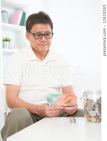 Mature Asian man counting money Mature Asian man counting money 12618383