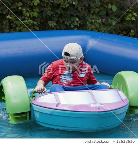 Boy having fun with bumper boats 12628630