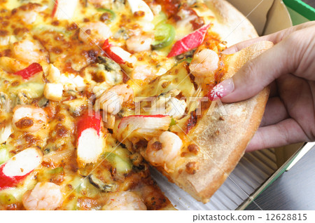 Hand picking up pizza Hand picking up pizza 12628815