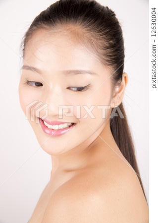 Asian young beautiful woman with flawless complexion smiling and looking down Asian young beautiful woman with flawless complexion smiling and looking down 12630004