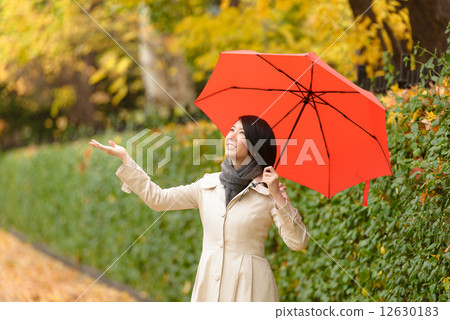 A woman with a red umbrella 12630183