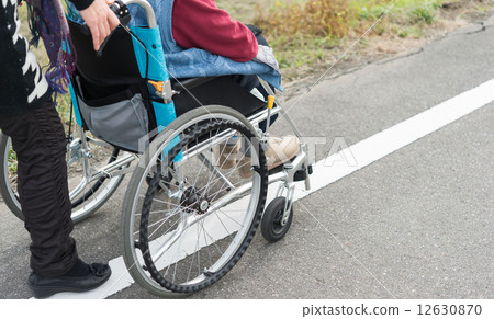 Walking with a wheelchair 12630870