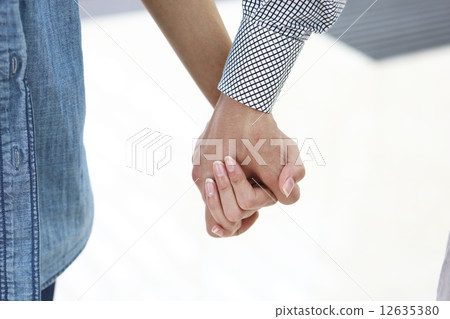 A couple connecting hands 12635380