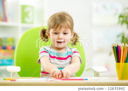 child girl drawing with colourful pencils child girl drawing with colourful pencils 12635842