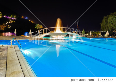 Water pool and fountain at night 12636722