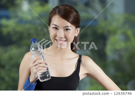 Fit Asian woman holding water bottle Fit Asian woman holding water bottle 12636746