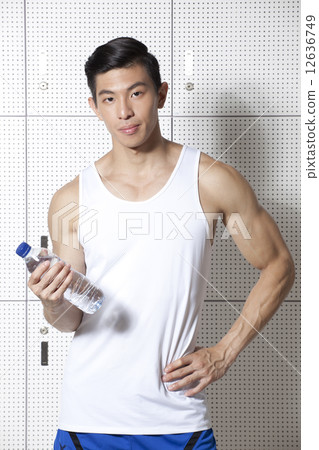 Fit Asian man holding water bottle Fit Asian man holding water bottle 12636749