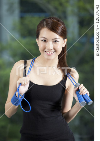 Fit Asian woman with skip rope 12637643