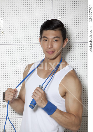 Fit Asian man with skip rope 12637704