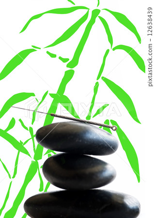 acupuncture needle on stone pyramid 12638439