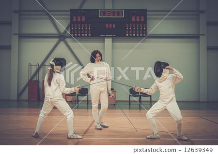 Children fencers and their  trainer 12639349
