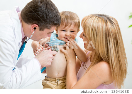 Pediatrician male doctor examining child. Mother holding baby. Pediatrician male doctor examining child. Mother holding baby. 12641688