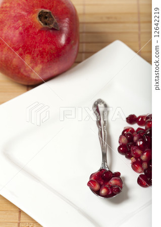 Pomegranate seeds on a spoon 12642219