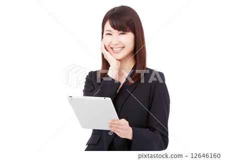 Businesswoman who laughs with a tablet 12646160