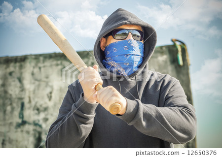 Man with a baseball bat at outdoor near wall Man with a baseball bat at outdoor near wall 12650376