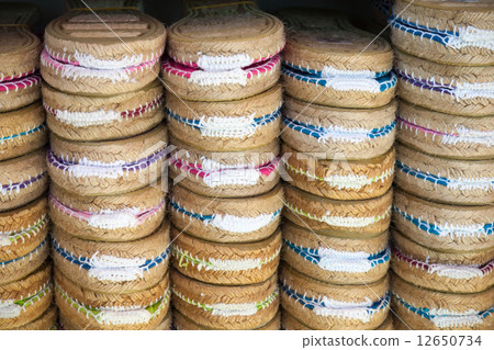 Colorful espadrilles for sale on a small shop counter in Spain 12650734