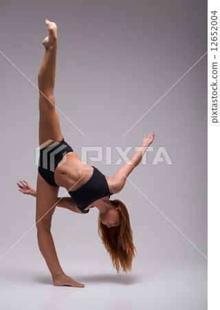 Woman gymnast stretching Woman gymnast stretching 12652004