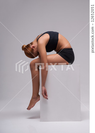 Woman gymnast stretching Woman gymnast stretching 12652051