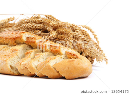 Bread and wheat ears on white background. 12654175